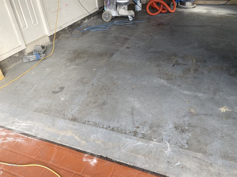 Garage floor before: bare, stained concrete