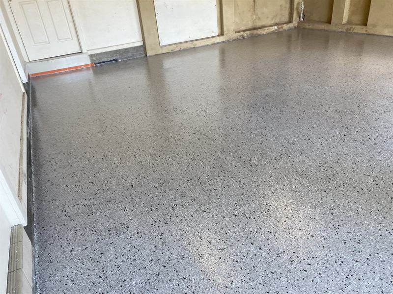 Garage floor after: grey epoxy with decorative flake finish