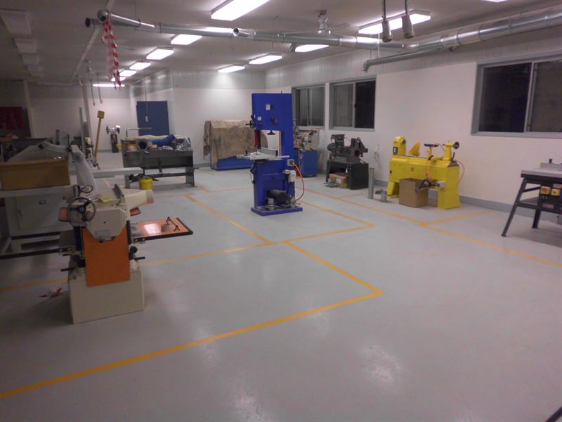 Light grey epoxy workshop floor with machine safety zones