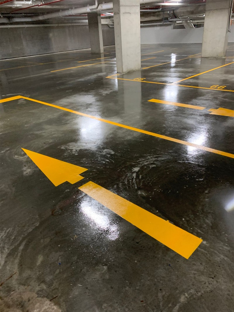 Direction arrow and bay lines in a sealed basement carpark