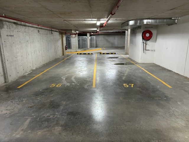 Numbered yellow bays in a residential basement carpark