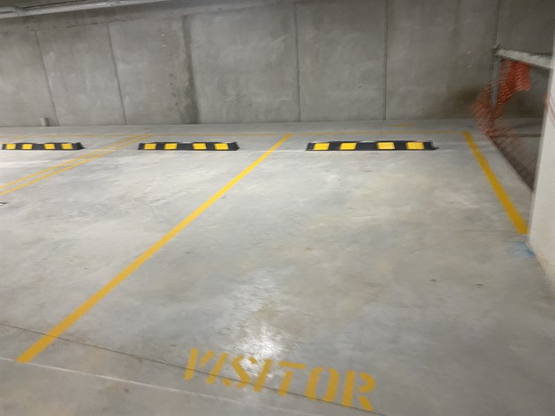 Visitor bays with wheel stops