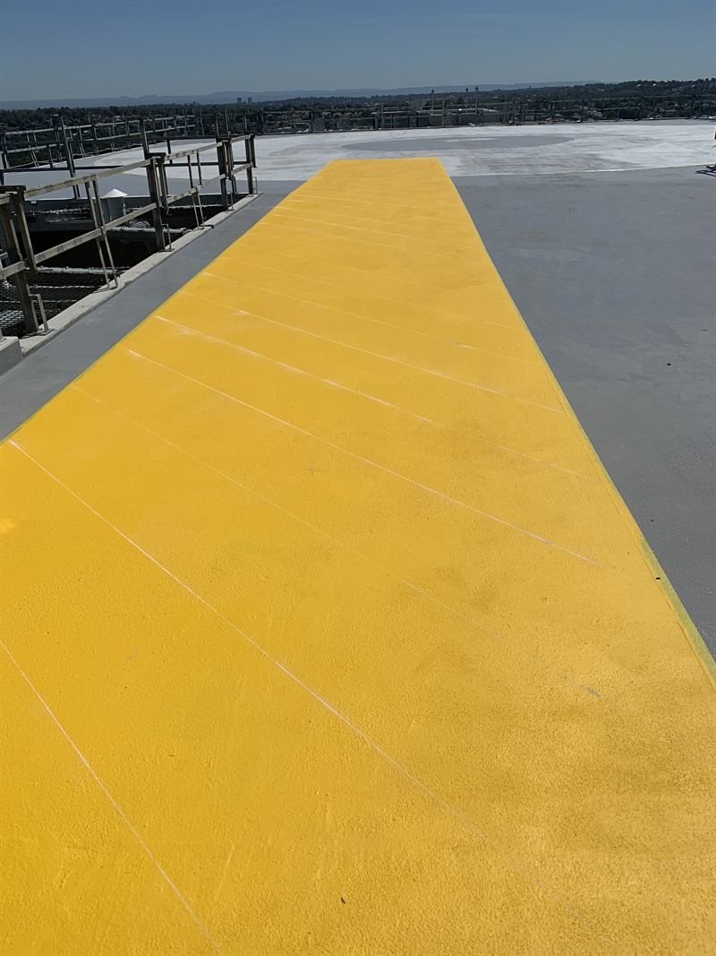 Yellow walkway onto a rooftop helipad